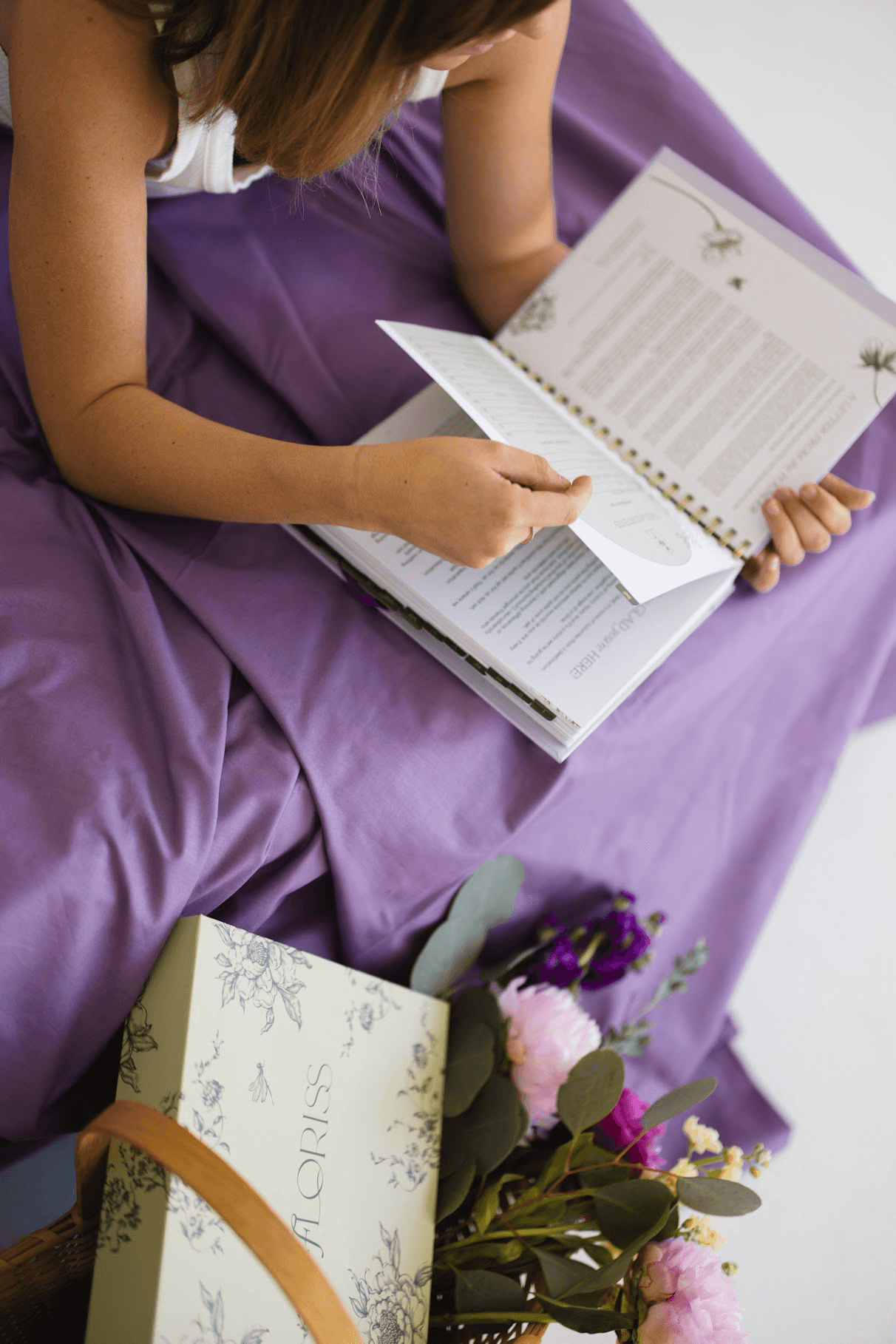 Overhead view of Floriss planner open on a desk with flowers